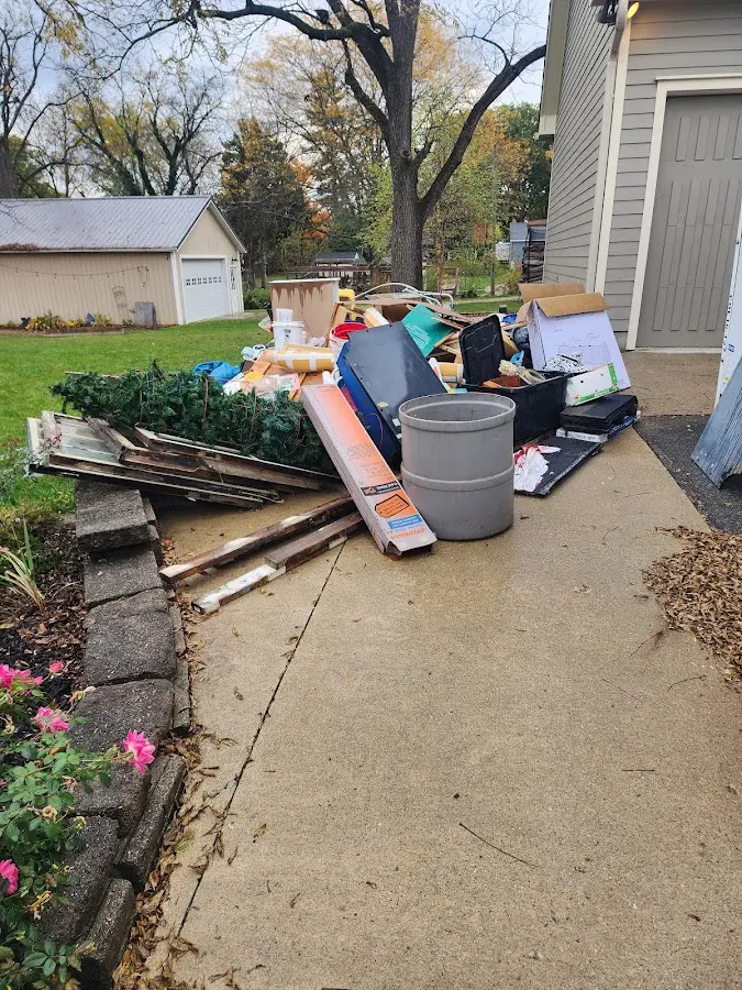 Dumpster being loaded with debris for 12 Yard Dumpster Rental in Fairfax